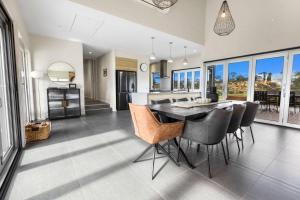 a kitchen and dining room with a table and chairs at Limestone Views in Swan Reach