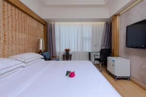 Voodi või voodid majutusasutuse Guangzhou Good International Hotel toas