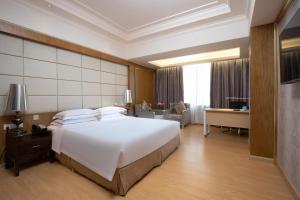 Voodi või voodid majutusasutuse Guangzhou Good International Hotel toas