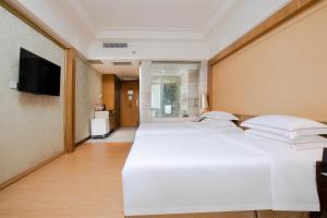 Voodi või voodid majutusasutuse Guangzhou Good International Hotel toas
