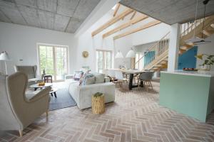 a living room with a couch and a table at Sąsny in Łajs
