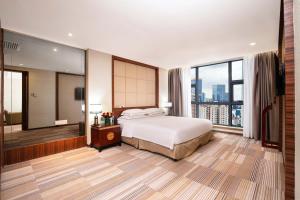 Voodi või voodid majutusasutuse Guangzhou Good International Hotel toas