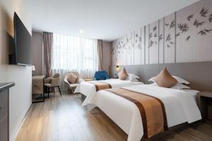 Postel nebo postele na pokoji v ubytování Ruilan Grandyard Hotel + 37 fotografií