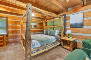 a bedroom with a bed in a log cabin at Whispering Pines in Townsend +28 photos