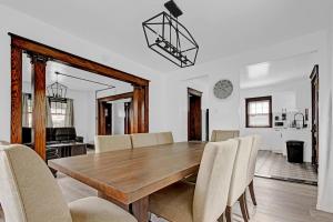 a dining room with a wooden table and chairs at Spacious 4BR 1BA near the Falls in Niagara Falls