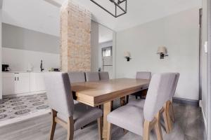 a dining room with a wooden table and chairs at Cozy 4BR 1BA close to the Falls in Niagara Falls