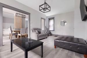 a living room with a couch and a table at Cozy 4BR 1BA close to the Falls in Niagara Falls