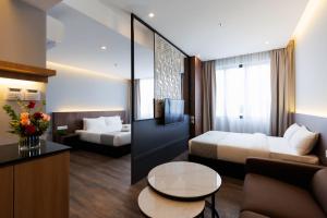 a hotel room with a bed and a couch at 56 Hotel Block A in Kuching +35 photos