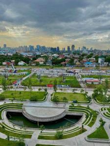 a view of a park with a city in the background at JoyStaycation Condo Hotel in Manila +16 photos