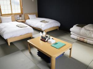 Postel nebo postele na pokoji v ubytování CHALET BURLAP FURANUI