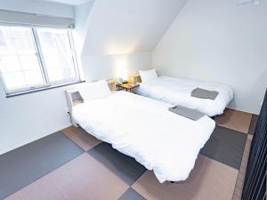 Postel nebo postele na pokoji v ubytování CHALET BURLAP FURANUI