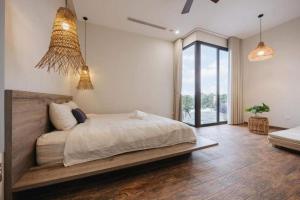 Postel nebo postele na pokoji v ubytování Velia Villa Venuestay + 27 fotografií