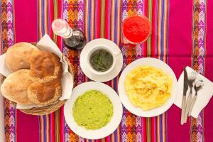 a table topped with plates of food and dip at Retablo Boutique Hotel in Ayacucho