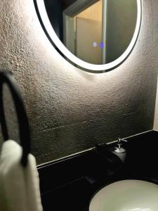 a person taking a picture of a bathroom with a mirror at Starlight Stays in Manning