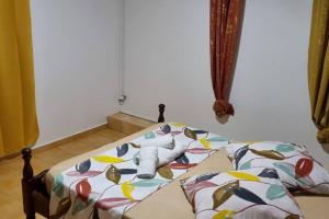 a bed with a comforter with a stuffed animal on it at L'ambre in Deshauteurs +2 photos