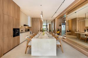 a kitchen and dining room with a white table and chairs at Alex Villas Complex N5 in Canggu