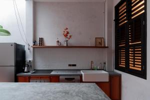 a kitchen with a sink and a refrigerator at Carnarvon Villa by Aayu George Town Penang in George Town