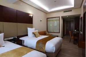 Postel nebo postele na pokoji v ubytování Regardal Hotel