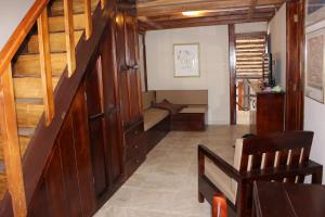 a hallway with a wooden staircase with a bench in it at Casa Aventura in San Clemente