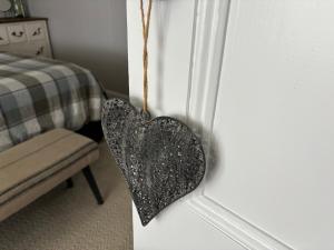 a heart hanging on the door of a bedroom at Cambridge Cottage in Cambridge +4 photos