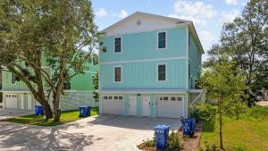 a blue and green house with two garage at DERBY BLUE A- Ocean Views- Garage & EV Charger in Myrtle Beach