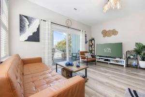 a living room with a couch and a tv at DERBY BLUE A- Ocean Views- Garage & EV Charger in Myrtle Beach