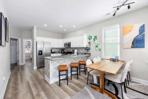 a kitchen and dining room with a table and chairs at DERBY BLUE A- Ocean Views- Garage & EV Charger in Myrtle Beach
