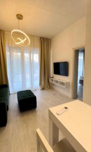 a living room with a couch and a tv at Apartments Sea Side in Petrovac na Moru