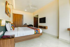 a hotel room with a bed and a tv at Swarnam Hotel in Old Goa +53 photos