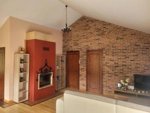 a living room with a brick wall and a couch at Cozy Corner in Saulkrasti