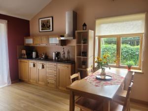 a kitchen with a table and a dining room at Cozy Corner in Saulkrasti +19 photos