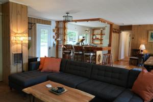 a living room with a couch and a table at Mary Lake Sunset Lodge in Port Sydney