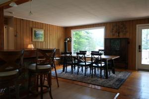 a dining room with a table and chairs at Mary Lake Sunset Lodge in Port Sydney