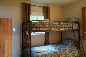 two bunk beds in a room with a window at Mary Lake Sunset Lodge in Port Sydney