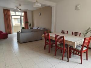 a living room with a table and chairs and a couch at Palmyrah Residencies in Colombo