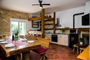 a kitchen with a wooden table and a dining room at Holiday home Anica in Čavoglave