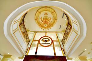 an ornate staircase in a building with a ceiling at Tuyet Son Hotel (TS Ocean Hotel) in Da Nang