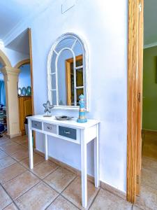 a bathroom with a white vanity with a mirror at Apartamento Primera Línea Marines Racons, Les Deveses, Denia in Casas Devesa