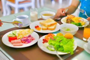 a table topped with plates of food on top at Tuyet Son Hotel (TS Ocean Hotel) in Da Nang