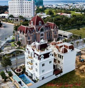 an aerial view of a large white building with a red roof at Homestay Ocean Real in Phan Thiet