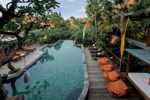 a pool at the resort at Fourteen Roses Boutique Hotel, Kuta in Legian