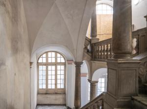 a hallway with a staircase and a window in a building at Spinola Palace Apartment in Genoa