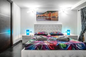 a bedroom with a bed and a painting on the wall at Spinola Palace Apartment in Genoa +56 photos