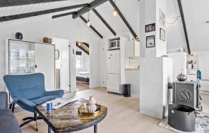 a living room with a blue chair and a table at 2 Bedroom Amazing Home In Thisted in Thisted