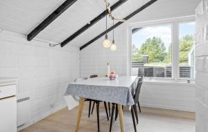 a white dining room with a table and chairs at 2 Bedroom Amazing Home In Thisted in Thisted