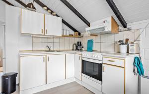 a kitchen with white cabinets and a stove at 2 Bedroom Amazing Home In Thisted in Thisted