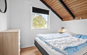 a bedroom with a bed and a window at 2 Bedroom Amazing Home In Thisted in Thisted +17 photos