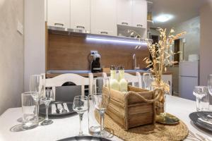 a table with glasses and a basket of wine bottles at Vutovi's corner made with care in Bansko