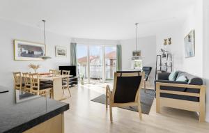 a living room with a table and a dining room at Gudhjem Søpark Lejl 42 in Gudhjem