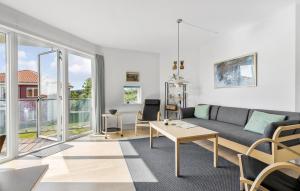 a living room with a couch and a table at Gudhjem Søpark Lejl 42 in Gudhjem
